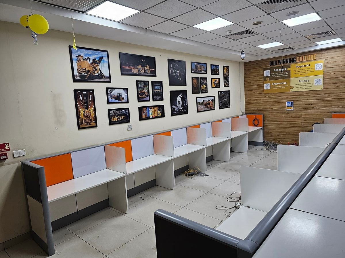 Caterpillar office workspace with workstations and gallery wall